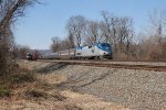 Amtrak 93 takes train 04T past a train waiting on the siding